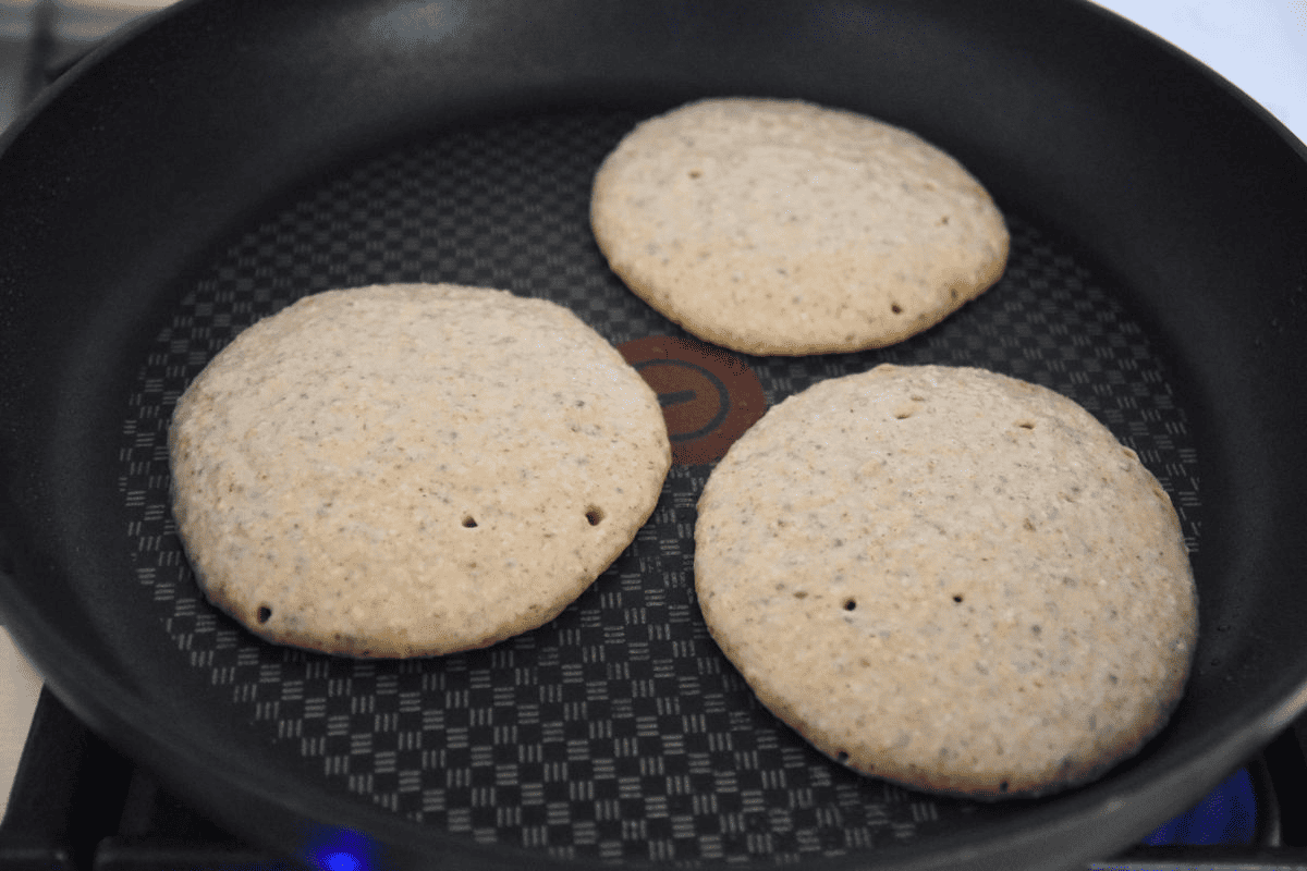 cooking oat pancakes on frying pan