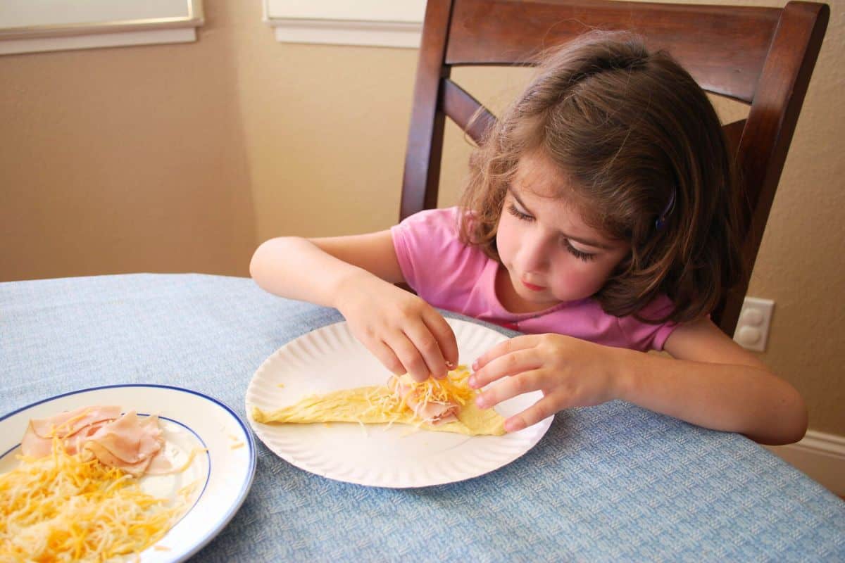 child making turkey and cheese crescent rolls.