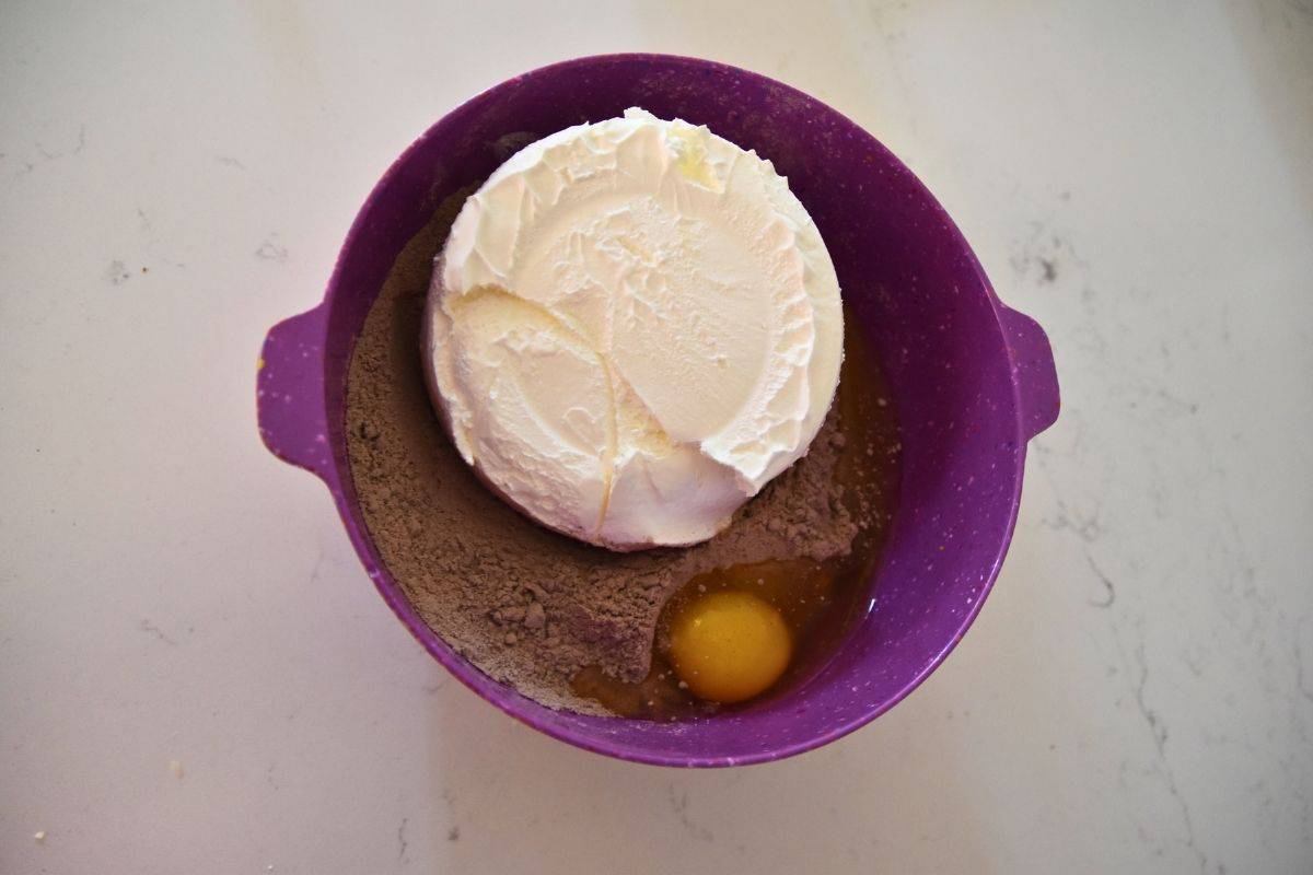 chocolate cake mix, egg and cool whip in bowl.