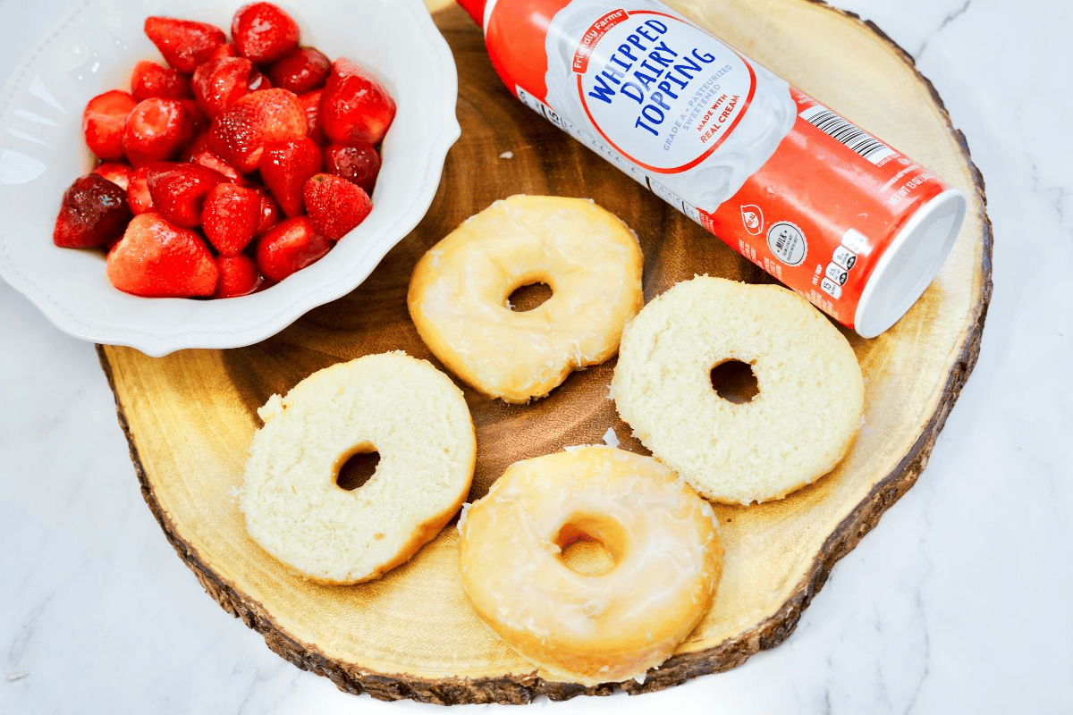 donuts sliced in half, strawberries and whipped cream