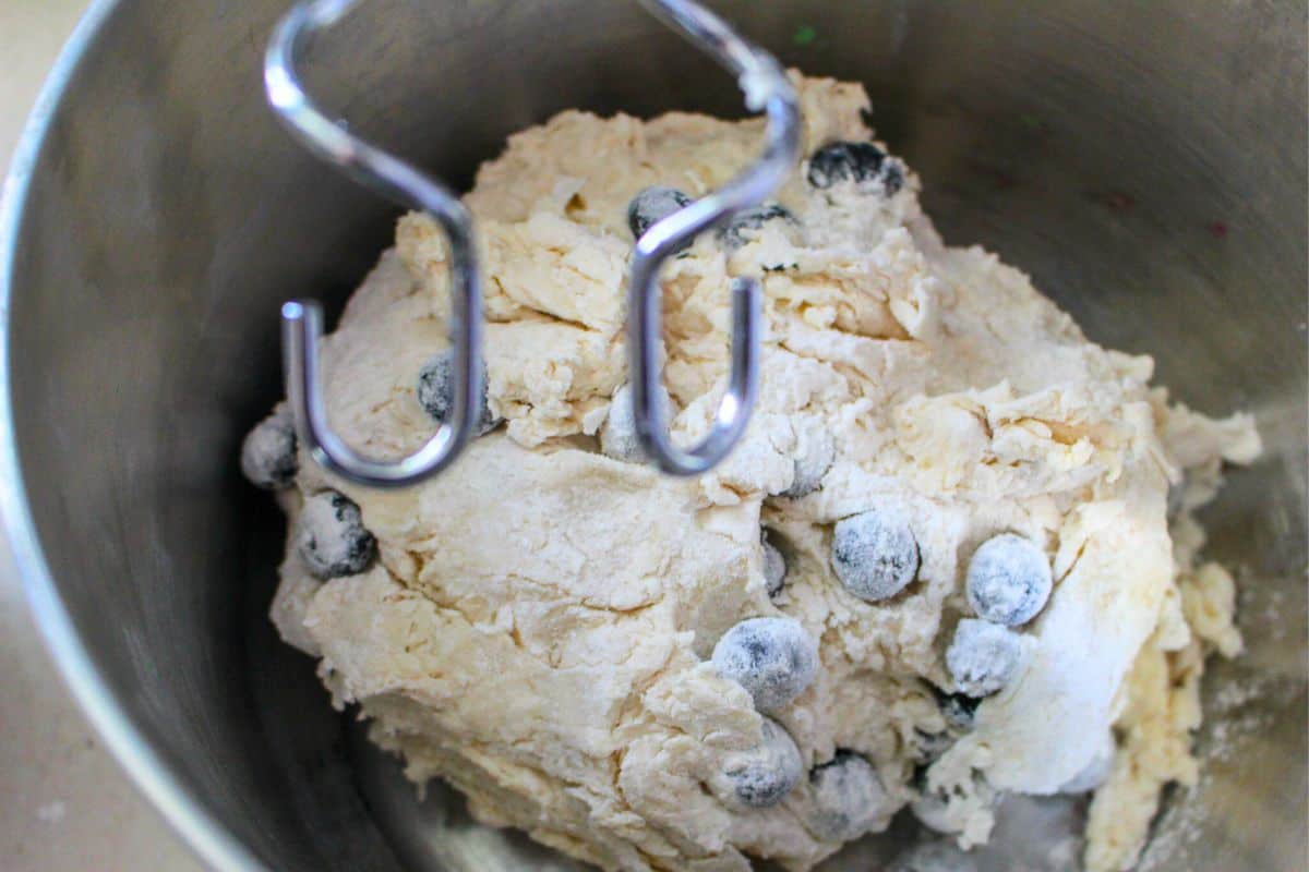 mixing blueberry bagel dough in a mixer.