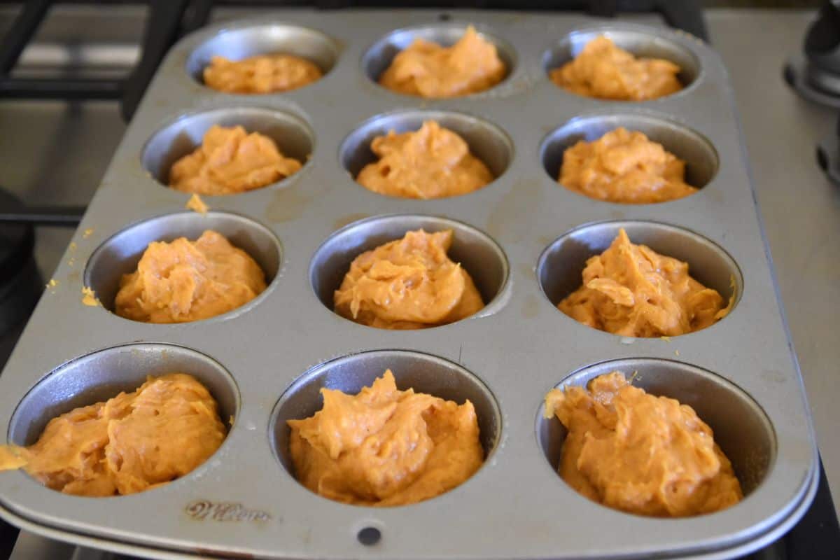pumpkin muffin batter in a muffin pan