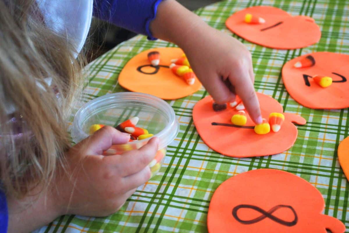 child counting candy corn