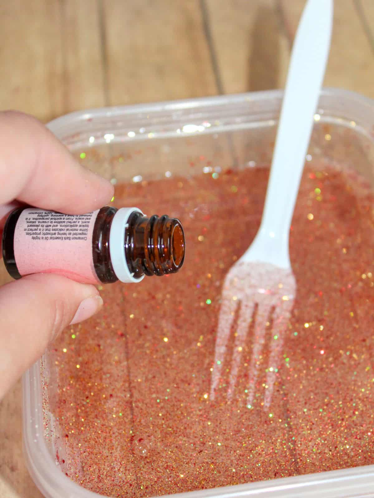 adding cinnamon essential oil to slime.