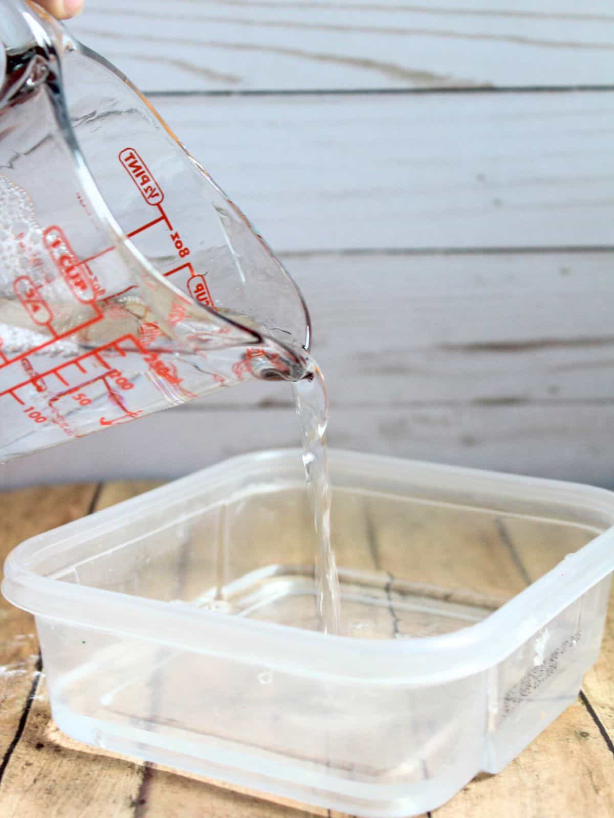 adding water to a container.