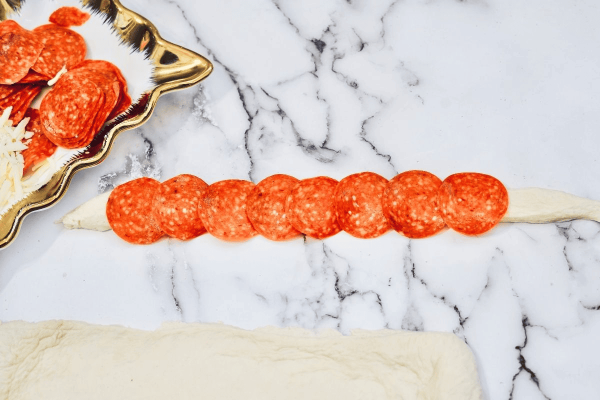 pepperoni on strip of dough.