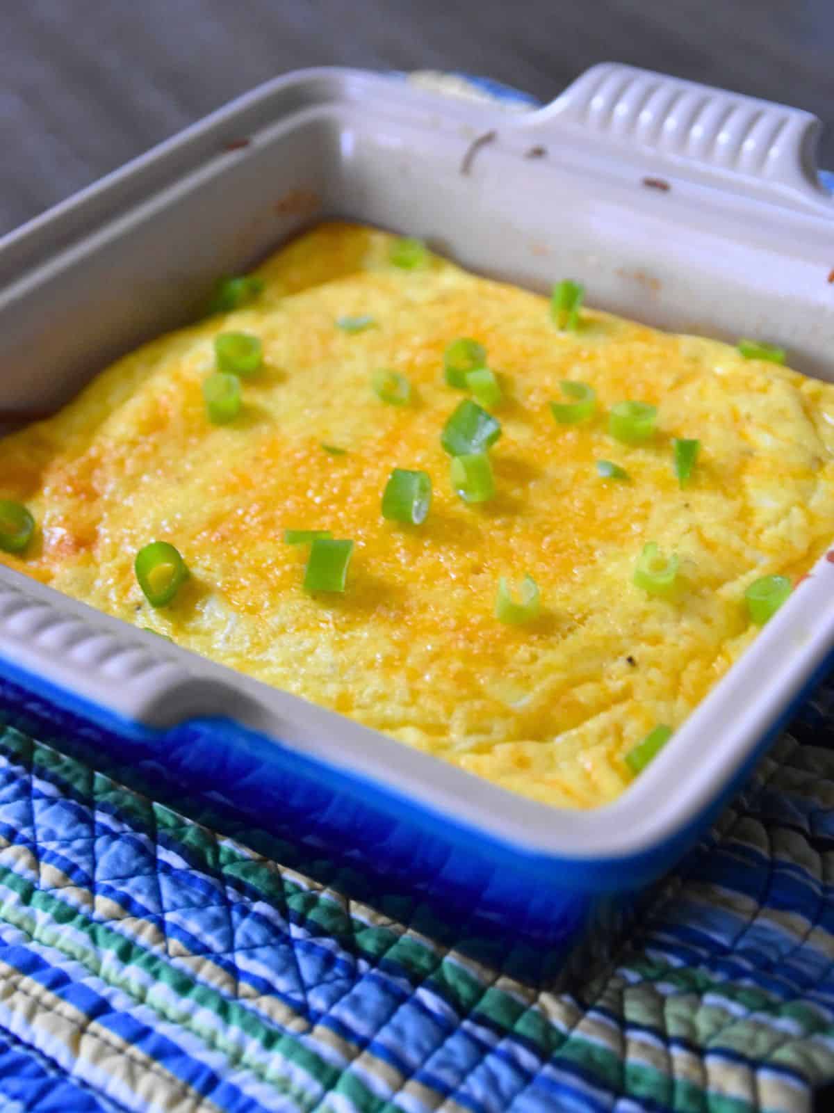 egg casserole with green onions on baking dish.