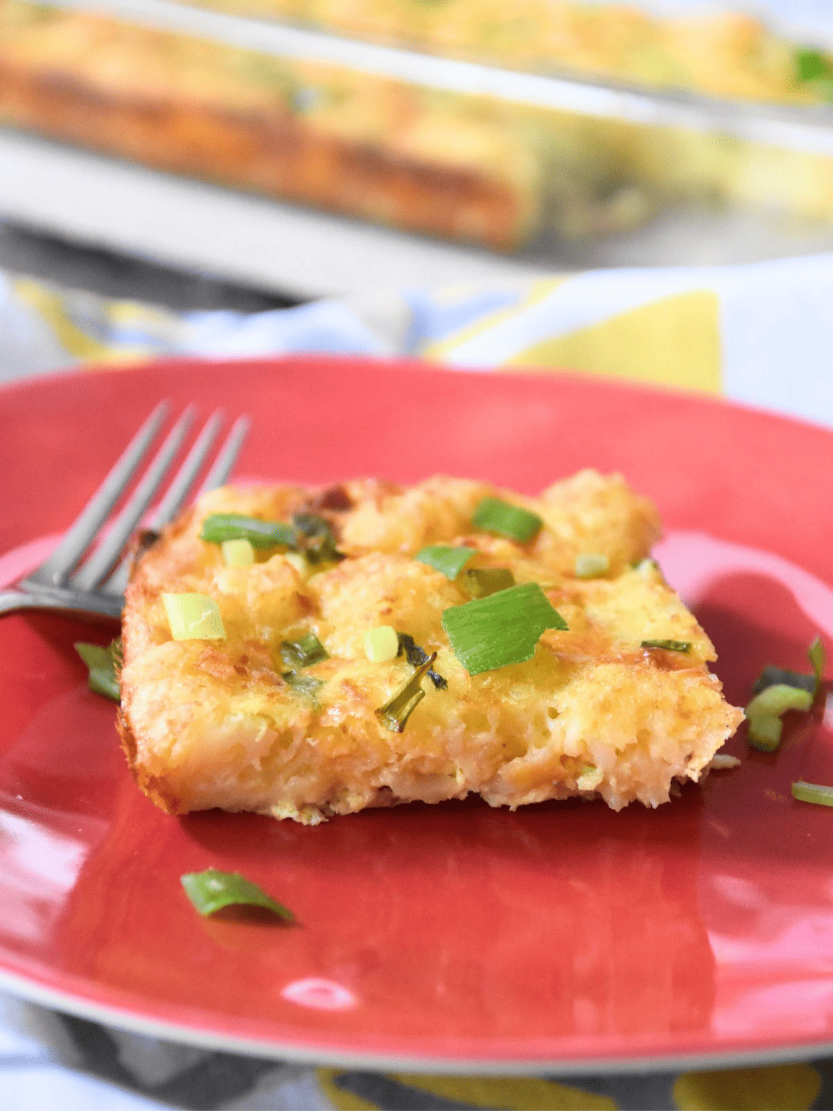 tater tot breakfast casserole won plate with fork.