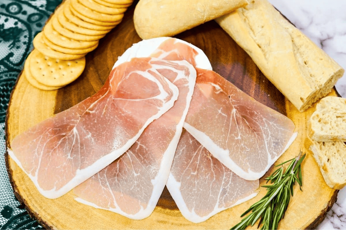 prosciutto slices on brie cheese.