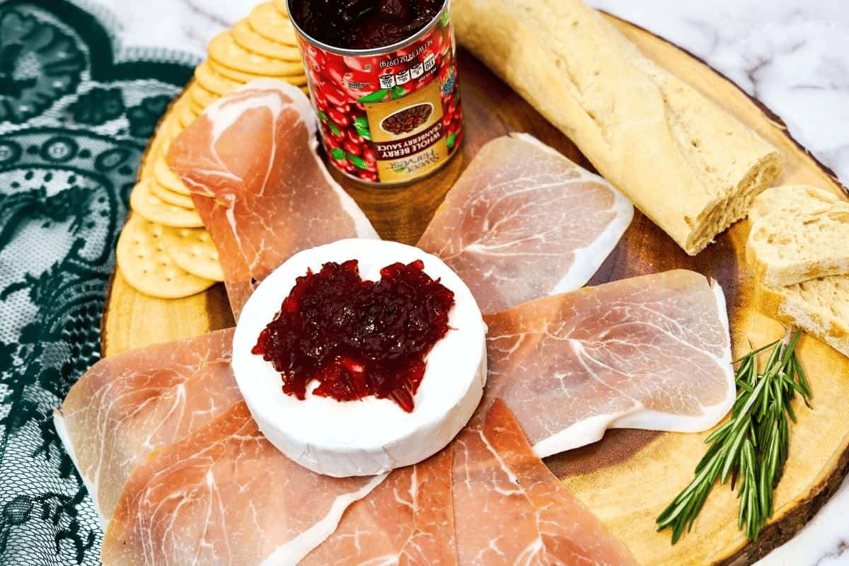 Brie cheese with prosciutto with cranberry sauce.