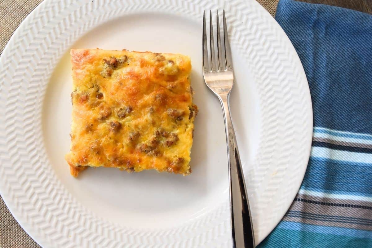casserole with sausage and eggs on white plate.