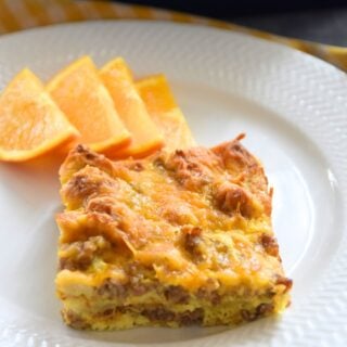 slice of breakfast casseron on plate with oranges