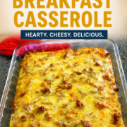 A delicious sausage egg and biscuit breakfast casserole is baked to perfection in a glass dish on the countertop.