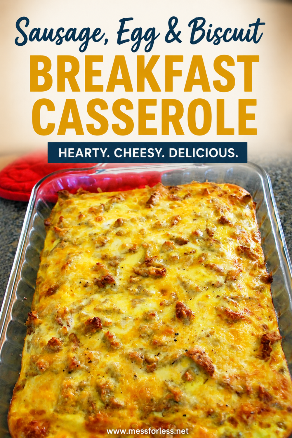 A delicious sausage egg and biscuit breakfast casserole is baked to perfection in a glass dish on the countertop.