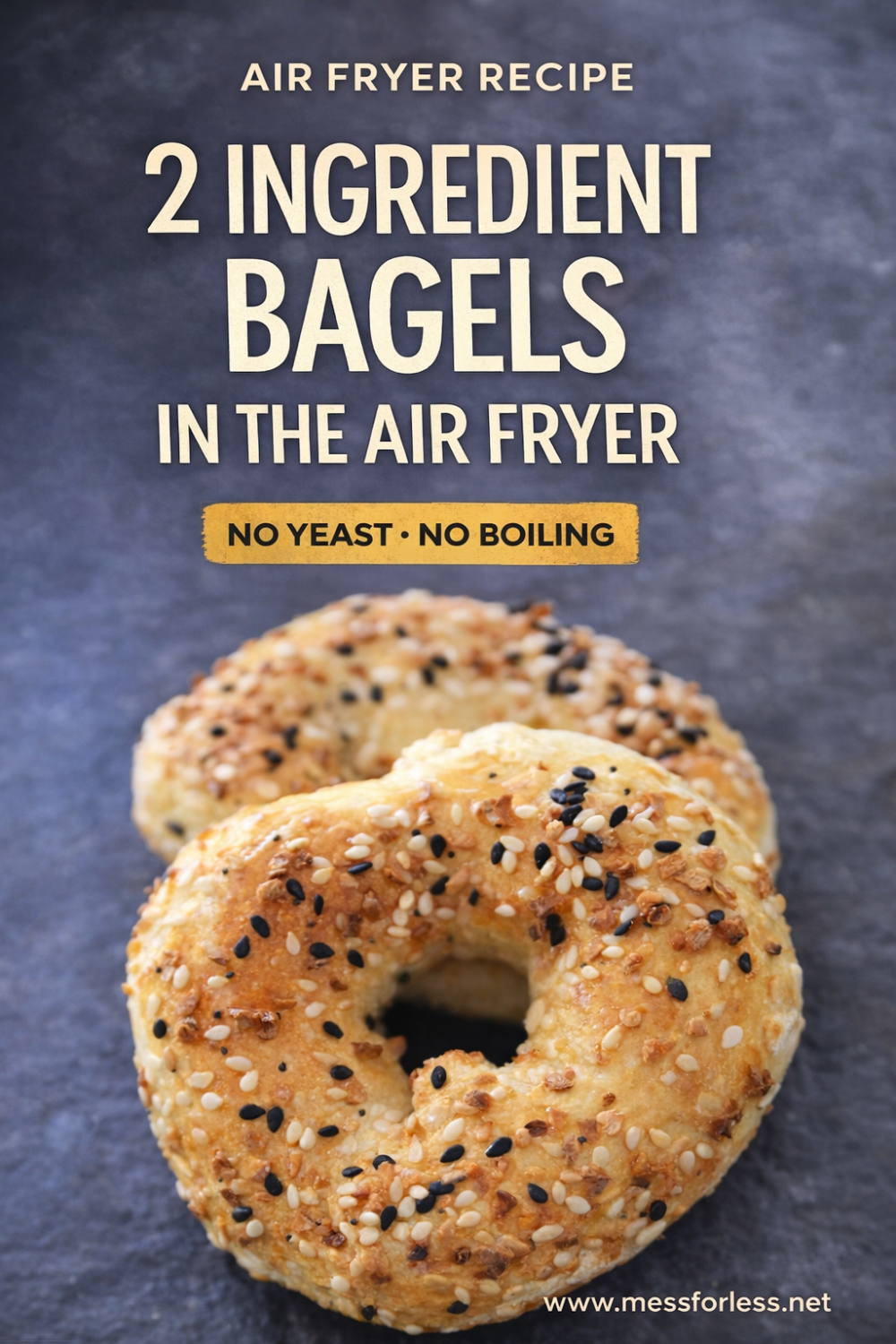 Two seeded bagels rest on a dark surface, highlighting the simplicity of this two ingredient bagels air fryer recipe.