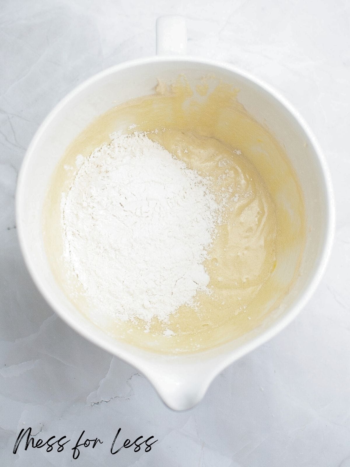 adding flour to cake batter