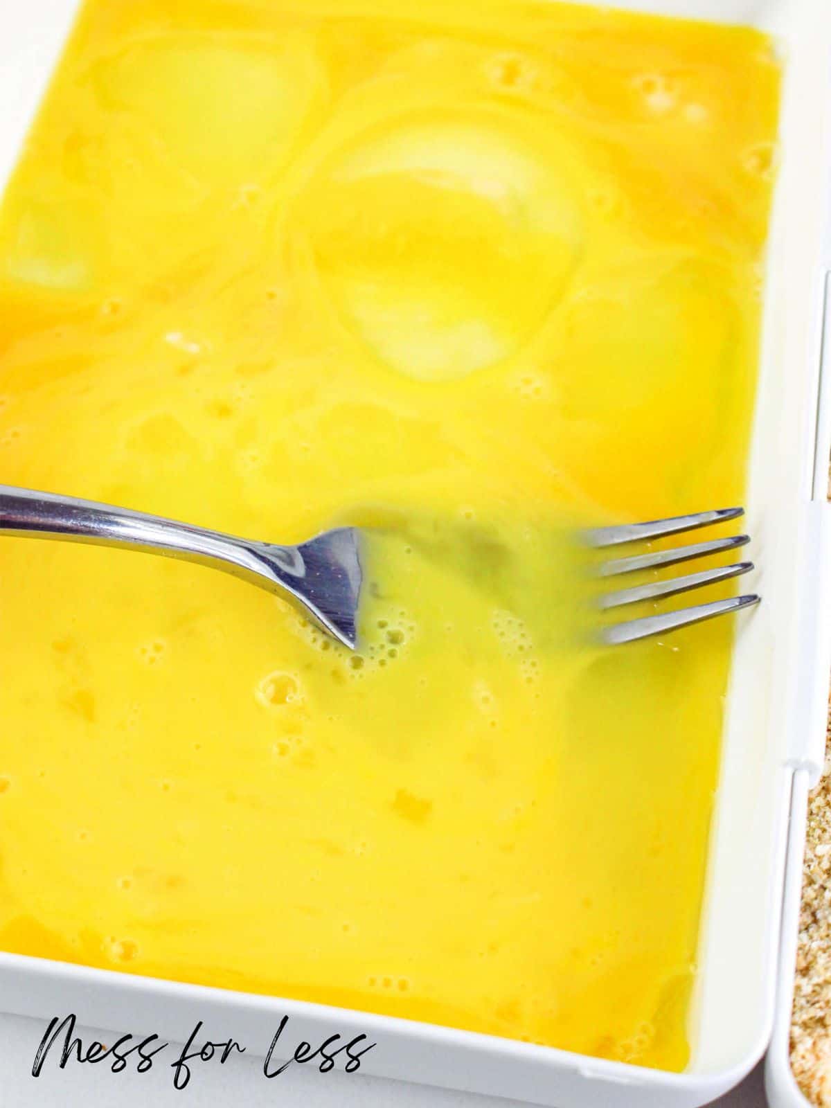 beating eggs with fork