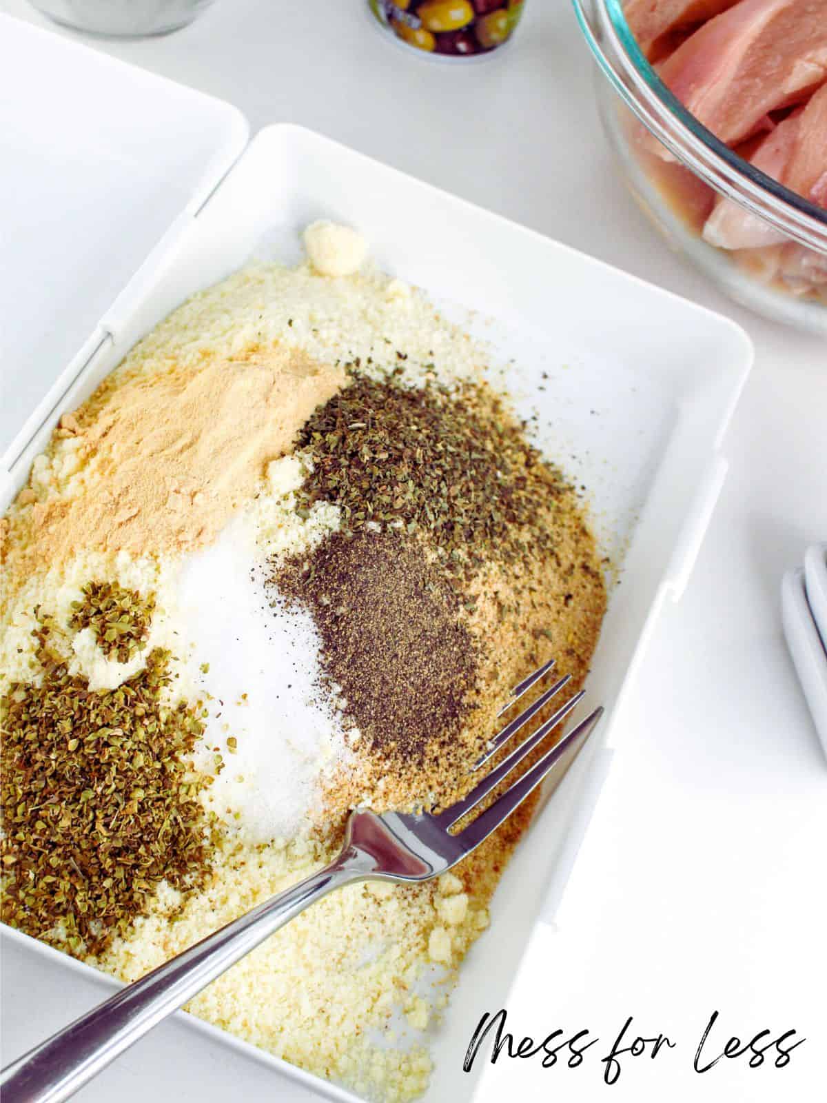 Mixing spices and bread crumbs to make breading for chicken