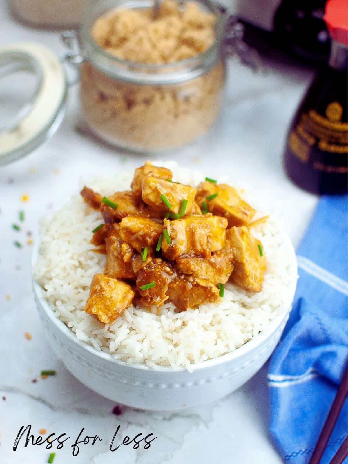 Orange chicken and white rice in white bowl