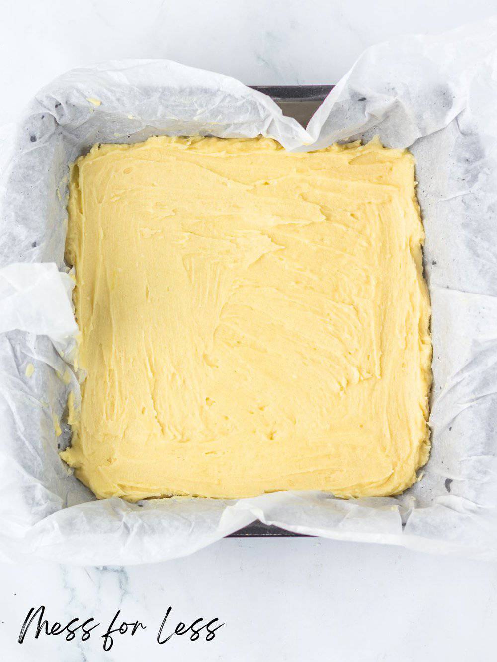 Shortbread crust in pan with parchment paper