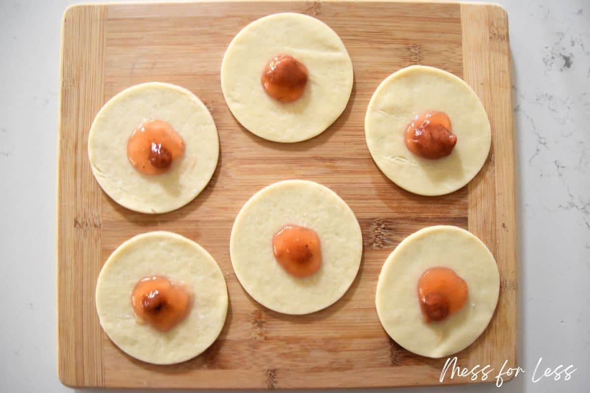 circles of pie crust with strawberry filling