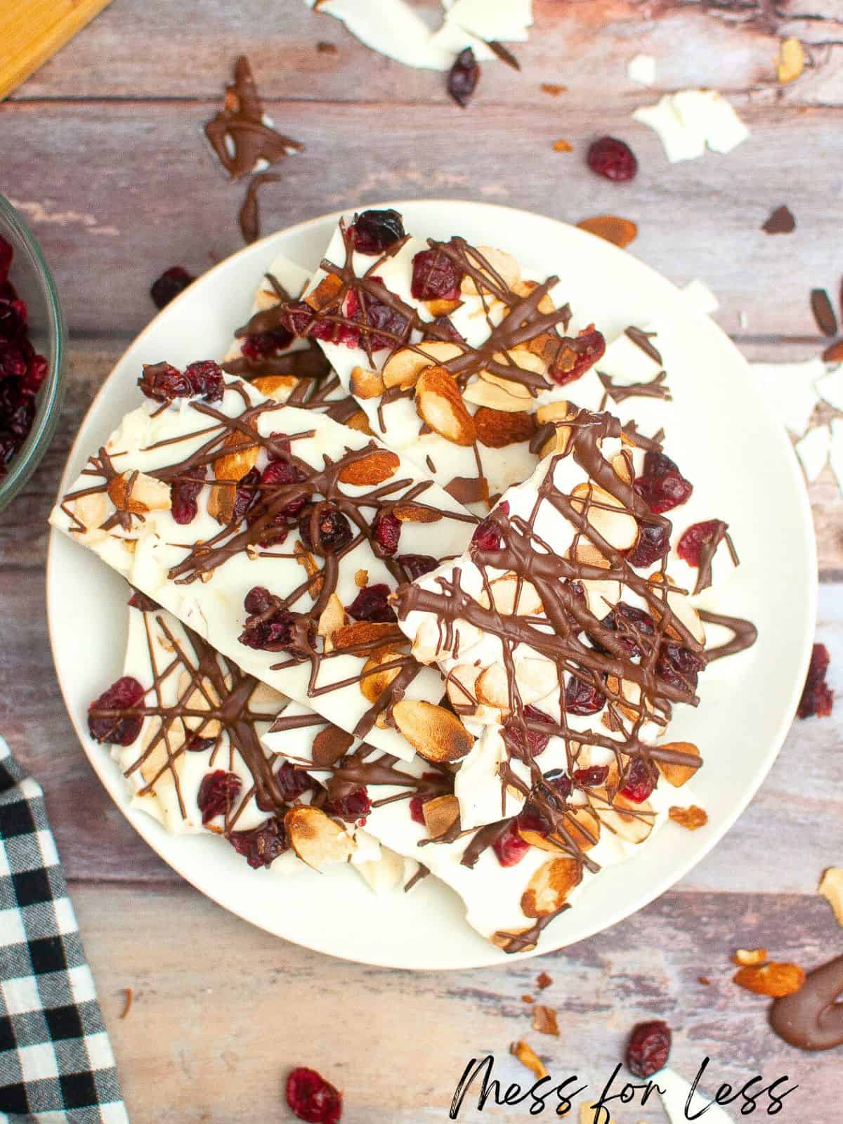 Pieces of cranberry almond bark on white plate