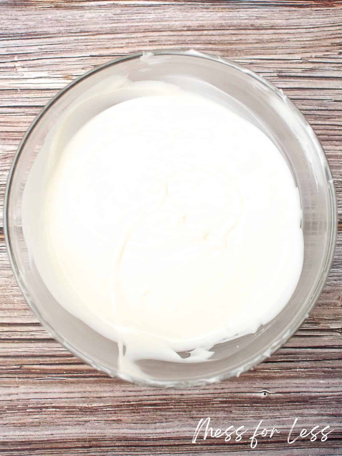 Melted white chocolate in glass bowl