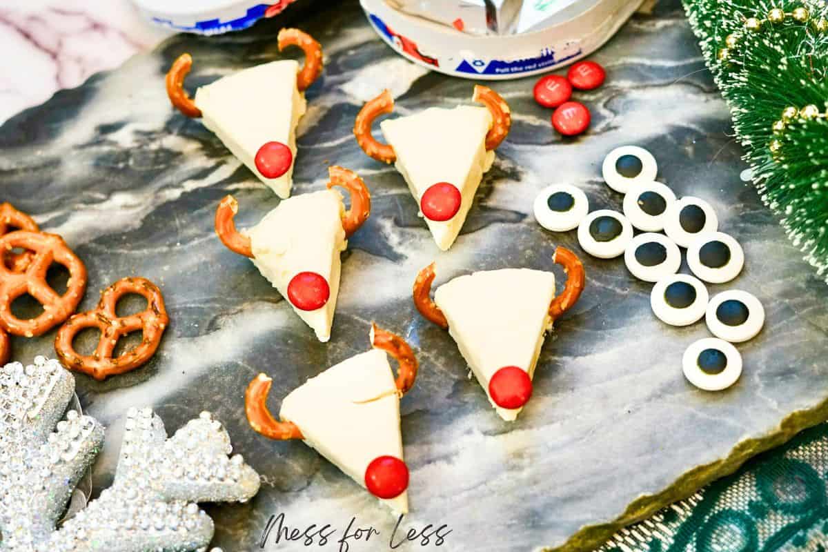 laughing cow cheese with pretzel antlers and m&m nose