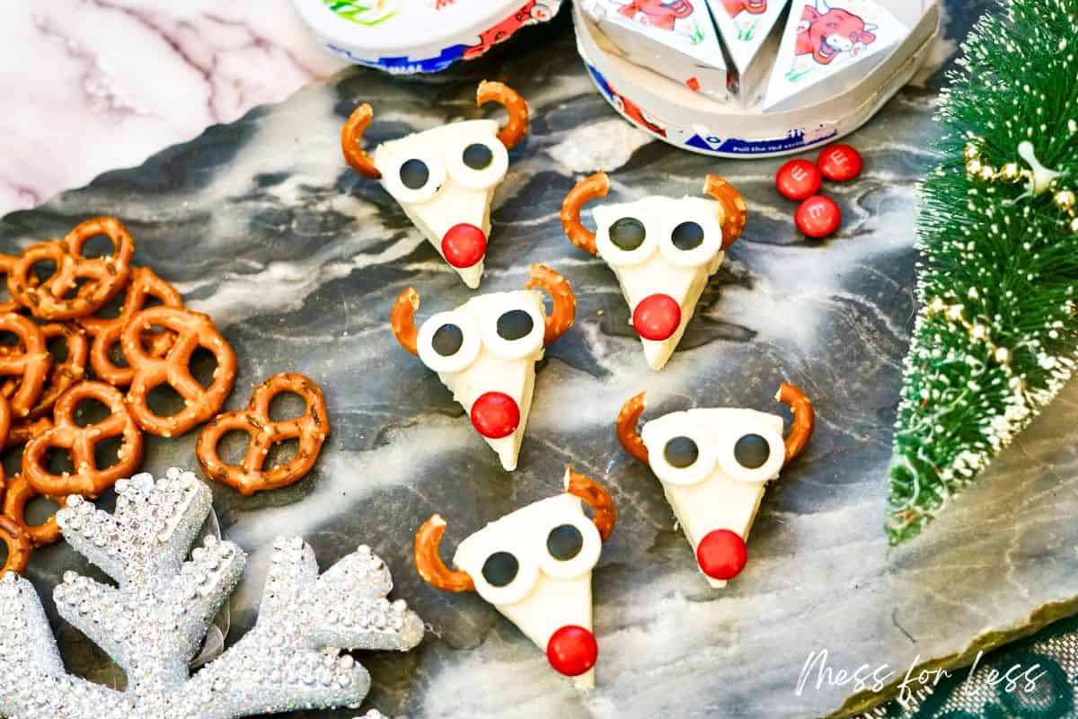 laughing cow cheese with pretzel antlers and m&m nose and candy eyes