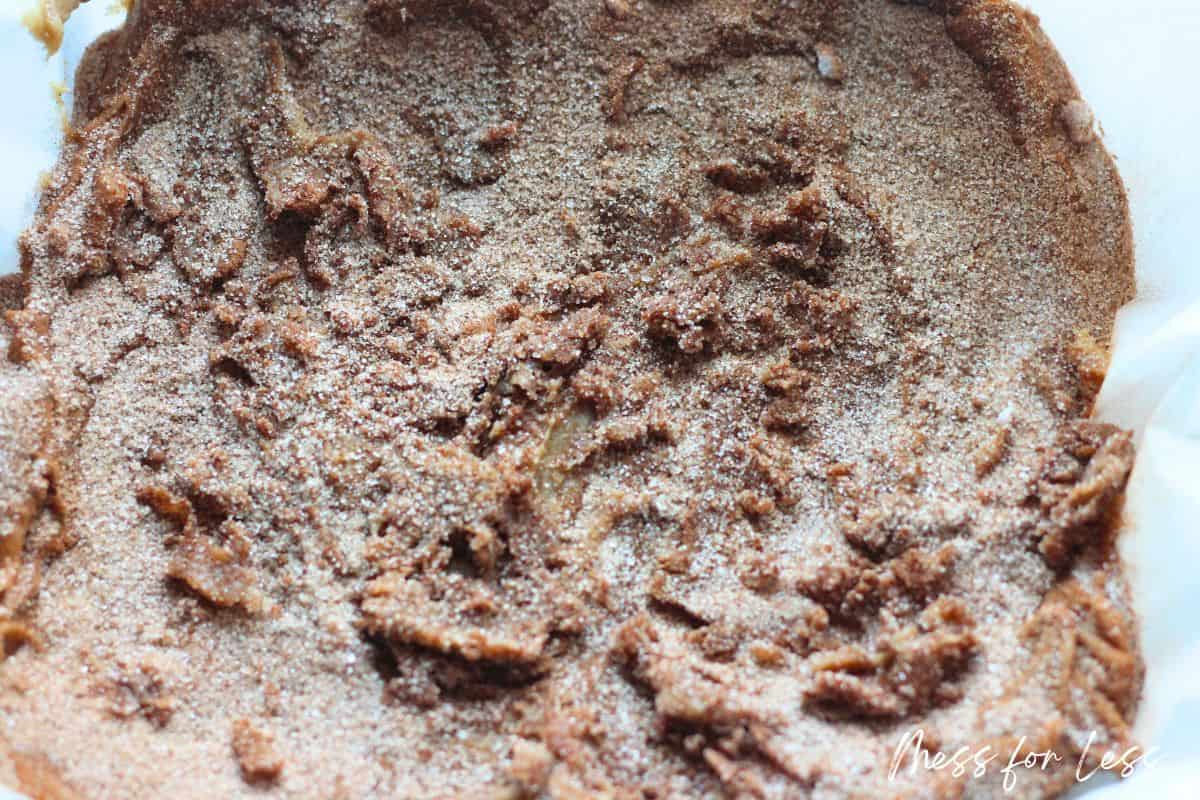 Adding cinnamon sugar topping to Blondie batter in a pan