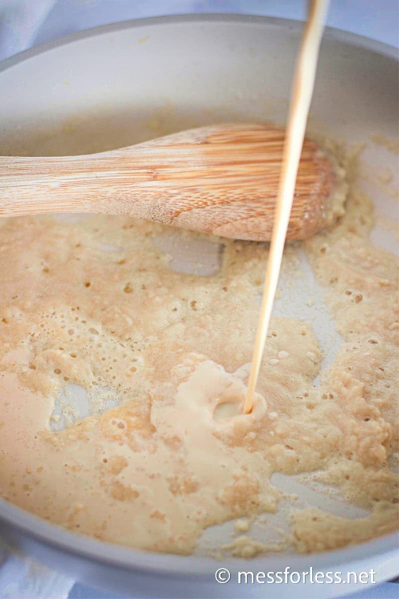 Butter and flour mixture bubbling in a pan as the base for a homemade cheese sauce.
