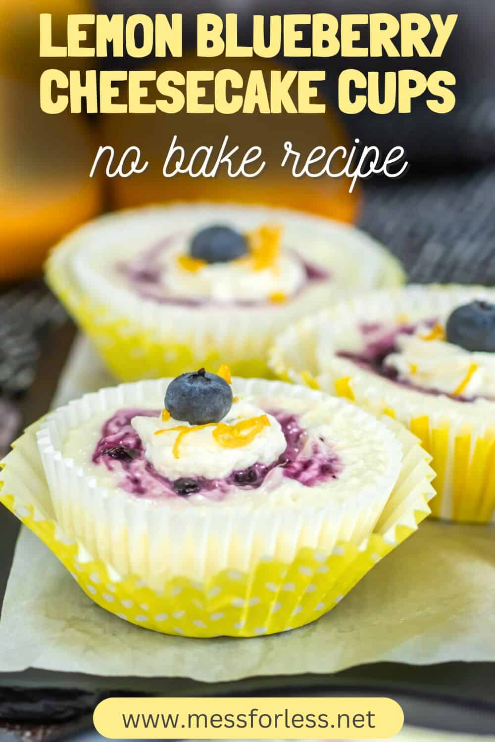 Lemon blueberry mini cheesecake cups topped with fresh blueberries and lemon zest in bright yellow wrappers, text overlay included.
