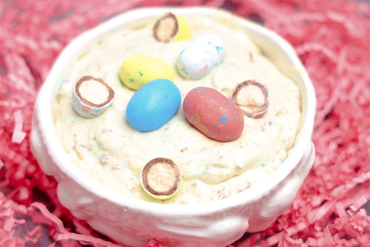 Robin's Egg Easter Dip in white bowl with pink easter grass background