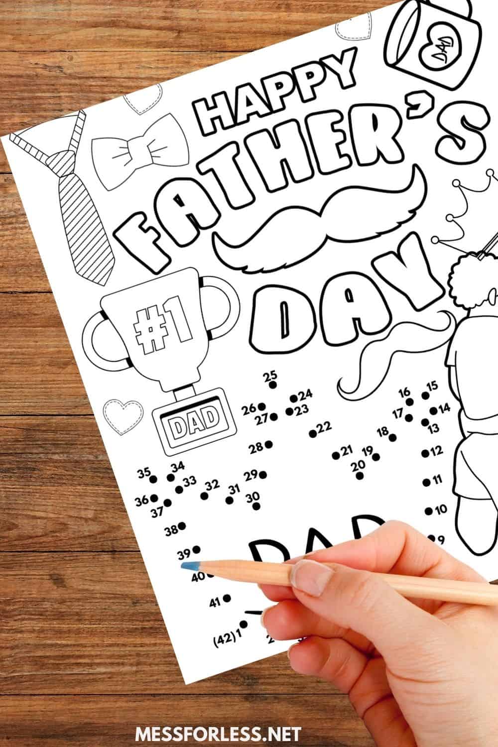 Hand coloring a Father’s Day themed dot-to-dot activity sheet on a wooden table—perfect as free printable placemats for your celebration.