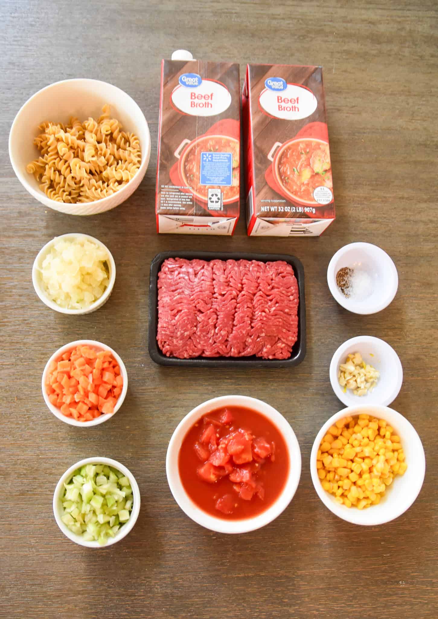 Ingredients for beef soup: rotini, beef broth, ground beef, onion, carrot, celery, tomato, corn, garlic, salt, and pepper create a hearty noodle soup perfect for cozy meals.