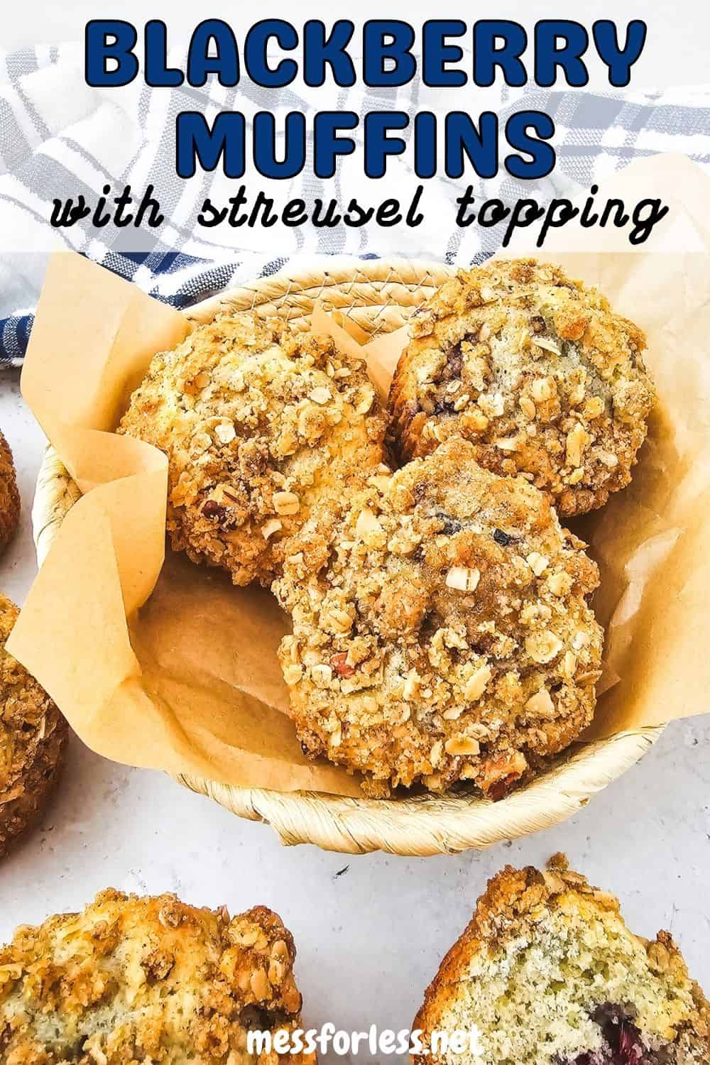 A basket of Blackberry Muffins with streusel topping sits on parchment paper, showcasing one muffin cut open in front
