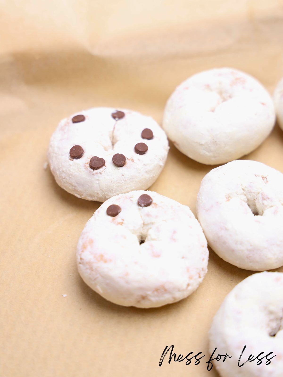 Powdered donuts on parchment; one Easy Donut features a smiley face made with chocolate chips.