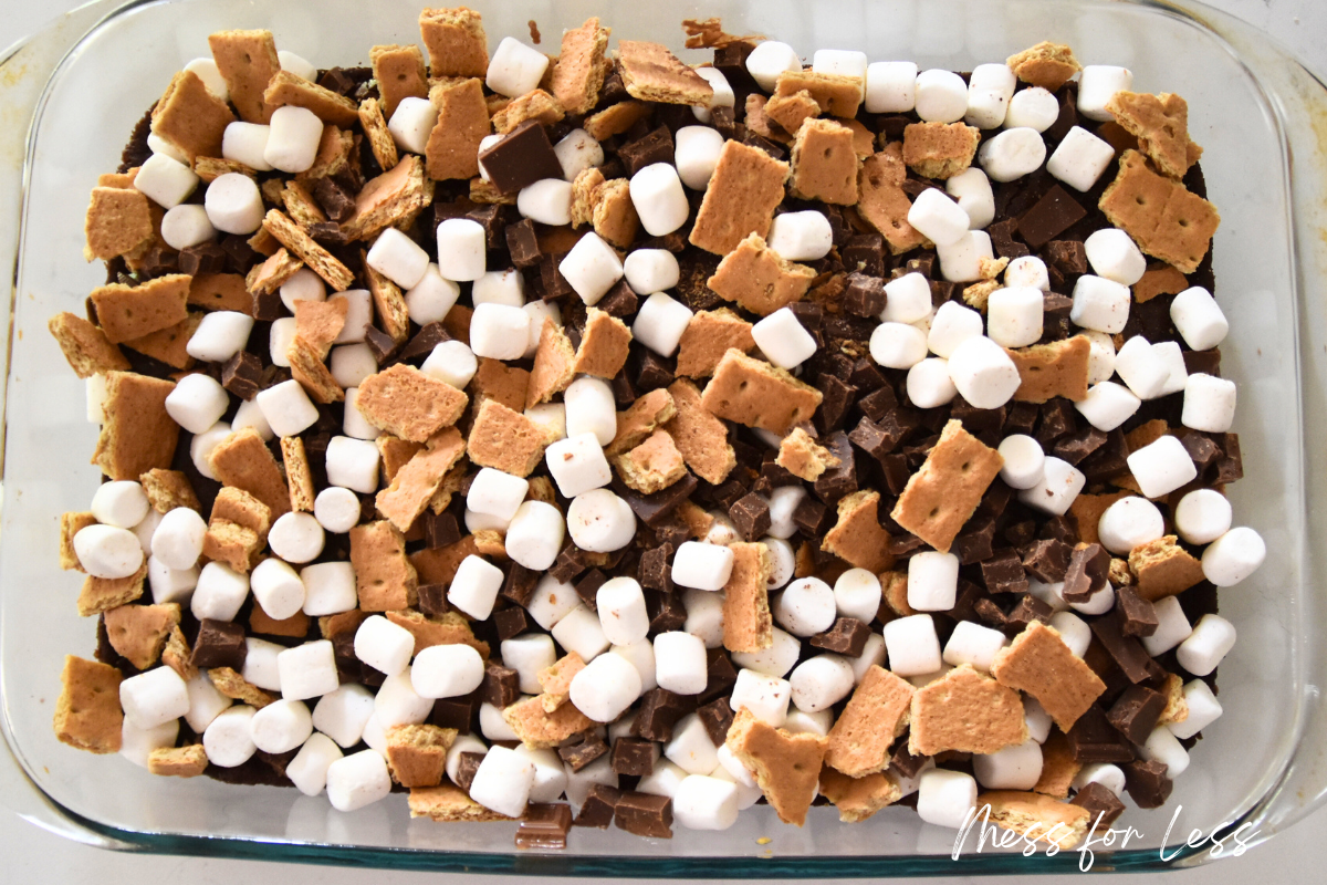 A baking dish filled with mini marshmallows, chocolate chunks, and broken graham crackers makes the perfect base for s'mores brownies using your favorite boxed brownie mix.